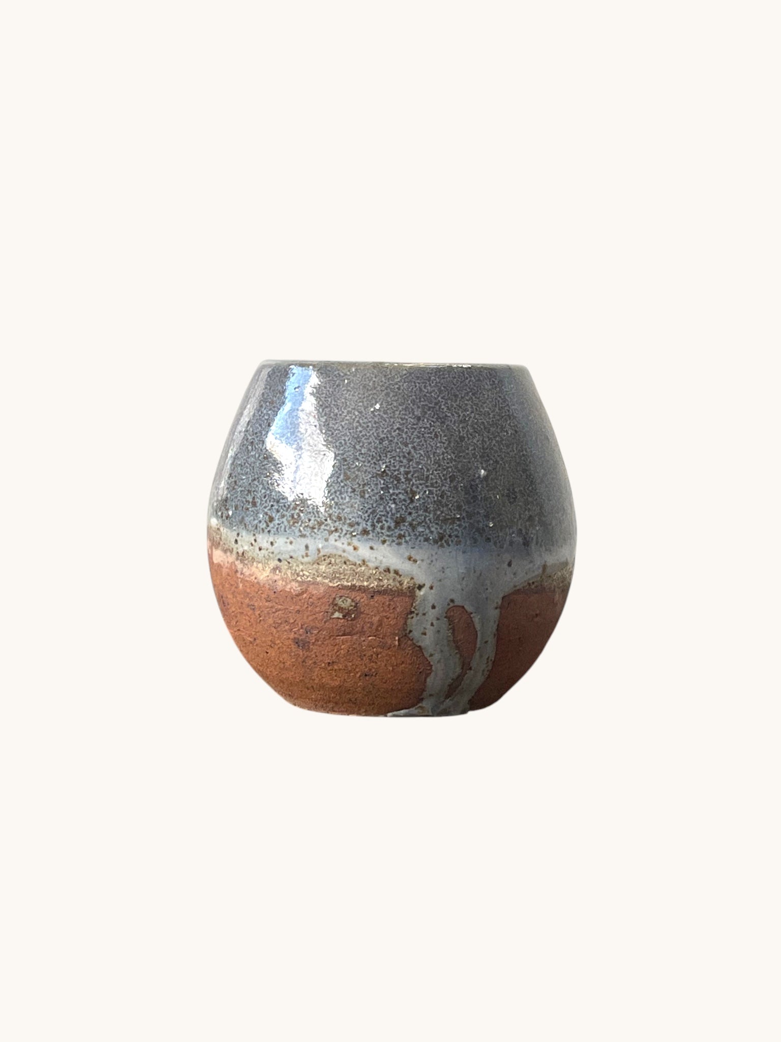 Matera Rob Original con vidriado negro azulado que escurre sobre la base terracota, vista frontal. Matera Rob®
